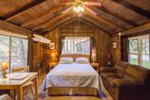 A peaceful, inviting cabin bedroom&mdash;rest well to the sound of the Big Sur River. (Thumbnail)