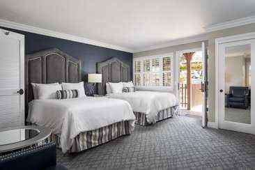 Image about Standard room with two double beds.