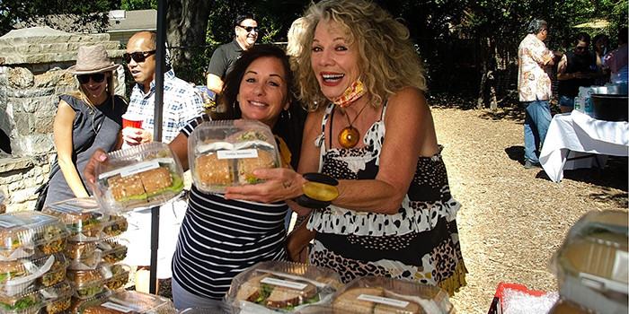 Special Events Committee volunteers Maryann Bologna and Marlin Handley serving boxed lunches at Member Appreciation Picnic