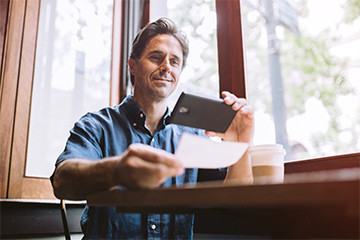 gentleman scanning check with mobile device