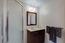 Bathroom with dark wooden cabinets (Image 16)