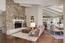 Living room with a showpiece stone fireplace (Image 3)