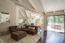 Living room with high, beamed ceiling and tree top views (Image 4)