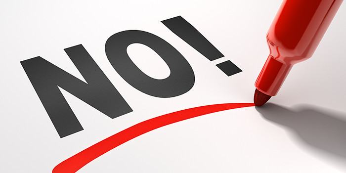 Photo of NO! on white page underlined in red with red felt pen