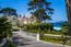 A private stone driveway leads through the grounds to the front of the home (Image 1)