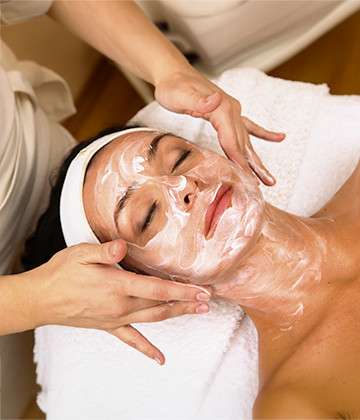Woman relaxing while receiving a facial treatment at a spa.