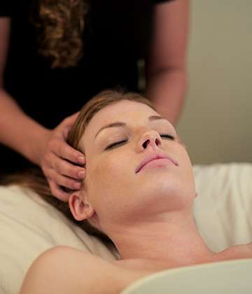 Image of woman enjoying a massage at Refuge.